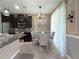 Cozy dining area with elegant lighting, wainscoting, and large window with decorative curtains at 26835 Juniper Bay Dr, Wesley Chapel, FL 33544