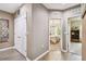 Hallway featuring wood-like flooring, closet space and entryways to multiple bedrooms at 26835 Juniper Bay Dr, Wesley Chapel, FL 33544