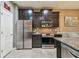 Modern kitchen with stainless appliances, subway tile backsplash, granite counter, and access to the dining area at 26835 Juniper Bay Dr, Wesley Chapel, FL 33544