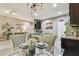 Open concept with island and seating, decorative lighting, and views to the kitchen and living area at 26835 Juniper Bay Dr, Wesley Chapel, FL 33544