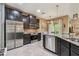 Modern kitchen with stainless steel appliances, dark wood cabinets, and granite countertops at 26835 Juniper Bay Dr, Wesley Chapel, FL 33544