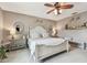Comfortable bedroom with a decorative ceiling fan, stylish furnishings and decor at 26835 Juniper Bay Dr, Wesley Chapel, FL 33544