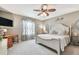 Comfortable bedroom with a decorative ceiling fan, stylish furnishings and decor at 26835 Juniper Bay Dr, Wesley Chapel, FL 33544