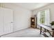 Bright office space featuring a window, a wooden bookshelf, and neutral decor, creating a functional workspace at 26835 Juniper Bay Dr, Wesley Chapel, FL 33544