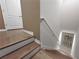 Staircase featuring modern wooden steps and a white handrail, providing access to upper or lower levels at 26835 Juniper Bay Dr, Wesley Chapel, FL 33544