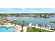 Aerial view of the property's pool, surrounding docks, and waterfront community on a clear day at 31 Island Way # 406, Clearwater Beach, FL 33767