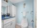 Bathroom with blue walls, white cabinets, and blue-marble countertop at 31 Island Way # 406, Clearwater Beach, FL 33767