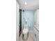Bright bathroom featuring a shower with glass doors, stylish vanity, and marble floors at 31 Island Way # 406, Clearwater Beach, FL 33767