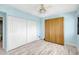 Light blue bedroom with ceiling fan and spacious closet at 31 Island Way # 406, Clearwater Beach, FL 33767