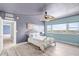 Cozy bedroom with view, ceiling fan, and light gray flooring at 31 Island Way # 406, Clearwater Beach, FL 33767