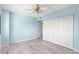Light blue bedroom with ceiling fan and spacious closet at 31 Island Way # 406, Clearwater Beach, FL 33767
