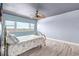 Bedroom featuring natural light, ceiling fan, and plank flooring at 31 Island Way # 406, Clearwater Beach, FL 33767