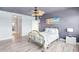Bedroom with ceiling fan, neutral walls, and wood-style floors at 31 Island Way # 406, Clearwater Beach, FL 33767