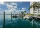 Beautiful view of the boats and jet skis docked near a condo complex, with a palm tree accentuating the sky at 31 Island Way # 406, Clearwater Beach, FL 33767
