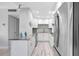 Modern kitchen with granite countertops, stainless steel appliances, and tiled backsplash with views of the door at 31 Island Way # 406, Clearwater Beach, FL 33767