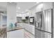 Bright kitchen with white cabinets, stainless steel appliances, and granite countertops at 31 Island Way # 406, Clearwater Beach, FL 33767