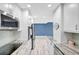 Galley kitchen with stainless steel appliances, granite countertops, and access to living area at 31 Island Way # 406, Clearwater Beach, FL 33767
