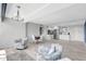 Living room with tile floors and an open floor plan, leading to a kitchen and dining area at 31 Island Way # 406, Clearwater Beach, FL 33767
