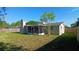 Beautiful view of the backyard and screened patio, perfect for outdoor entertaining and relaxation at 3150 Beacon Square Dr, Holiday, FL 34691
