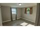 Cozy bedroom with wood-look flooring and two windows offering natural light at 3150 Beacon Square Dr, Holiday, FL 34691