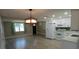 Well-lit kitchen featuring white cabinets, stainless steel appliances, and an open layout at 3150 Beacon Square Dr, Holiday, FL 34691
