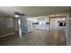 Spacious open-plan kitchen with white cabinets, modern appliances, and wood-look flooring at 3150 Beacon Square Dr, Holiday, FL 34691