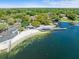 Beautiful aerial view of the community beach area featuring a dock, lake access, and ample parking at 3325 Schefflera Rd, Tampa, FL 33618