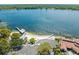 Stunning aerial view showcasing the community beach and dock extending into the lake at 3325 Schefflera Rd, Tampa, FL 33618