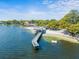 Scenic aerial view of the community beach with a long pier extending into the pristine lake at 3325 Schefflera Rd, Tampa, FL 33618