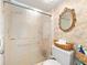 Bathroom showcasing a glass shower door, decorative wallpaper, and a toilet at 3325 Schefflera Rd, Tampa, FL 33618
