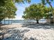 Charming beach area featuring picnic tables, a volleyball net, and a covered shelter for relaxation at 3325 Schefflera Rd, Tampa, FL 33618