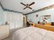 Bedroom featuring light blue walls, a ceiling fan, a desk and a wooden dresser at 3325 Schefflera Rd, Tampa, FL 33618