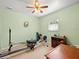 Bedroom with neutral green walls, fan, window, and exercise equipment at 3325 Schefflera Rd, Tampa, FL 33618