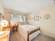 Charming bedroom with floral wallpaper, a window, and a wooden bed frame at 3325 Schefflera Rd, Tampa, FL 33618