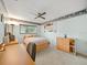 Bedroom featuring light blue walls, a ceiling fan, a desk and a wooden dresser at 3325 Schefflera Rd, Tampa, FL 33618