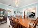 Elegant dining room with light-blue walls, light fixture and direct access to living areas at 3325 Schefflera Rd, Tampa, FL 33618
