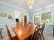 Charming dining room featuring natural light and classic wooden furniture with blue walls at 3325 Schefflera Rd, Tampa, FL 33618