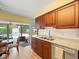 Well-equipped kitchen with backyard pool views and wood cabinets at 3325 Schefflera Rd, Tampa, FL 33618
