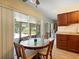 Cozy kitchen nook with a round table and view to the pool area and screened in porch at 3325 Schefflera Rd, Tampa, FL 33618