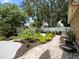 Beautifully landscaped backyard with a stone pathway and a variety of plants at 3325 Schefflera Rd, Tampa, FL 33618