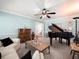 Comfortable living room with a grand piano and plush seating at 3325 Schefflera Rd, Tampa, FL 33618