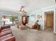 Spacious living room features comfortable seating and a view to the outdoor pool area at 3325 Schefflera Rd, Tampa, FL 33618