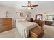 Comfortable bedroom with vintage decor, a ceiling fan, and warm-toned walls at 3325 Schefflera Rd, Tampa, FL 33618