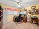 Functional office space with yellow walls, desk with printer, and ceiling fan at 3325 Schefflera Rd, Tampa, FL 33618