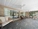 Spacious screened-in patio with slate tile floor, ceiling fans, and access to a pool at 3325 Schefflera Rd, Tampa, FL 33618