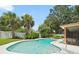 Backyard featuring a sparkling pool, lush tropical landscaping, and a privacy fence at 3325 Schefflera Rd, Tampa, FL 33618