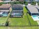 Aerial view of the property showcasing a large backyard, screened-in pool, and mature landscaping at 3477 Barbour Trl, Odessa, FL 33556