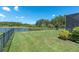 Lush backyard overlooking a serene lake view, enhanced with mature landscaping at 3477 Barbour Trl, Odessa, FL 33556