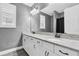 Bathroom featuring a double vanity with granite counters, white cabinets, and modern fixtures at 3477 Barbour Trl, Odessa, FL 33556