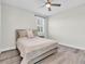 Bedroom with neutral walls, a ceiling fan and a window with plantation shutters at 3477 Barbour Trl, Odessa, FL 33556